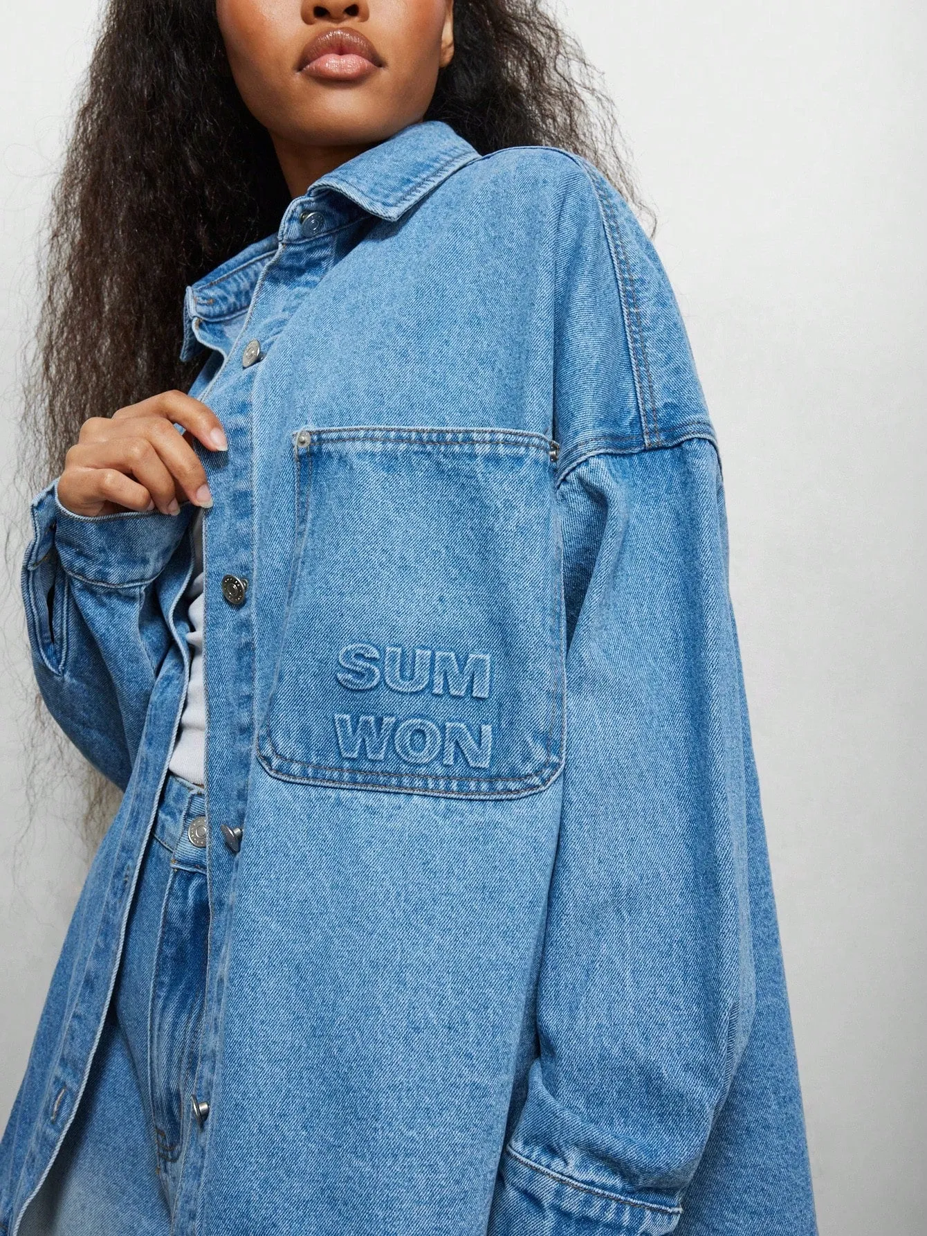 SUMWON WOMEN Oversized Denim Curve Hem Shirt With Front Pocket Emboss Print